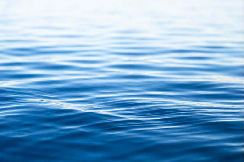 Calm water with gentle ripples symbolizing reflection and healing during grief.