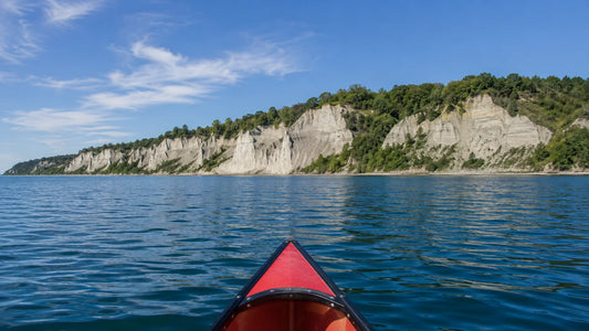 A vibrant view of the iconic Scarborough Bluffs along Lake Ontario Is Still Lake Ontario, showcasing natural beauty and calm waters.