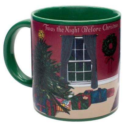 The "Twas the Night Before Christmas Heat-Changing Mug" by Danna Bananas is a delightful holiday gift that features a Christmas scene with a decorated tree, wrapped presents, and a wreath against a red wall. Pour in your drink to magically reveal the text "'Twas the Night Before Christmas.