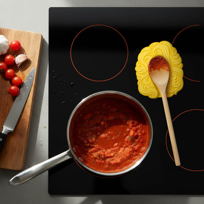 Dolly Parton Spoon Rest on Stove Top with Tomatoe Sauce