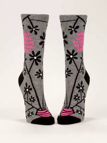 The "Most Likely To Say It To Your Face Crew Socks" by Danna Bananas showcase a gray design adorned with black flowers and branches, accented by playful pink elements. These novelty socks for women also feature pink text that humorously states, "I want to party to forget about my problems," making them perfect for those in search of funny socks with a touch of flair.