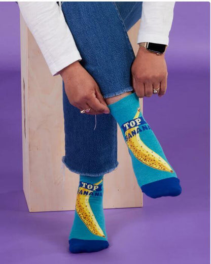 A woman wearing and holding the top of her Top Banana Socks