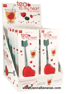 The image highlights the "Tea to My Heart" Tea Infuser from Danna Bananas, an ideal Mother's Day gift. Each heart-shaped infuser includes an arrow and the packaging presents it inside a cup. At the bottom of the display, you can see "www.DannaBananas.com".
