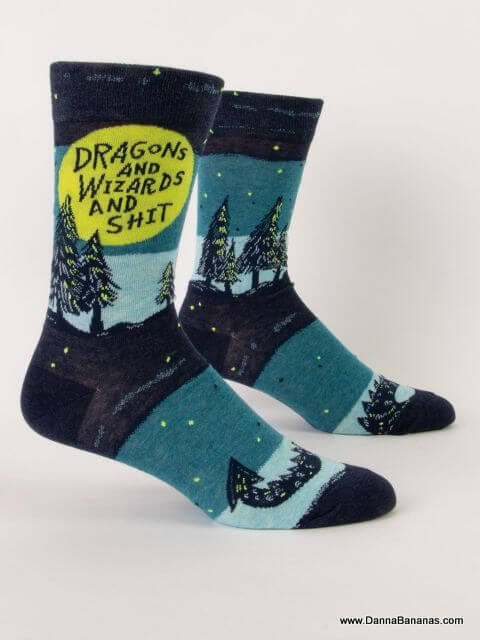 Front view of funny men’s crew socks reading “Dragons and Wizards and Shit” with a night sky and forest scene — a whimsical fantasy gift that gives back.
