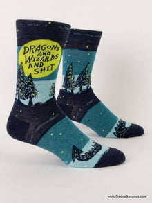 Front view of funny men’s crew socks reading “Dragons and Wizards and Shit” with a night sky and forest scene — a whimsical fantasy gift that gives back.