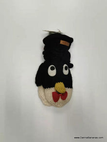 The Penguin Mitts - Kids by Danna Bananas are knitted penguin mittens made from soft New Zealand wool, featuring a black body, white face, yellow beak, and red bow tie. They hang against a plain background with delightful charm.