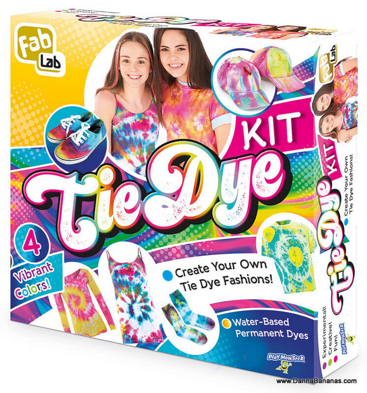 The packaging of the Outset Media Tie Dye Kit is eye-catching with its display of vibrant clothing and accessories. Boasting "4 Vibrant Colors," it invites you to "Create Your Own Tie Dye Fashions!" using non-toxic, hypo-allergenic, water-based permanent dyes. The box is adorned with the image of two smiling individuals, emphasizing the fun experience.