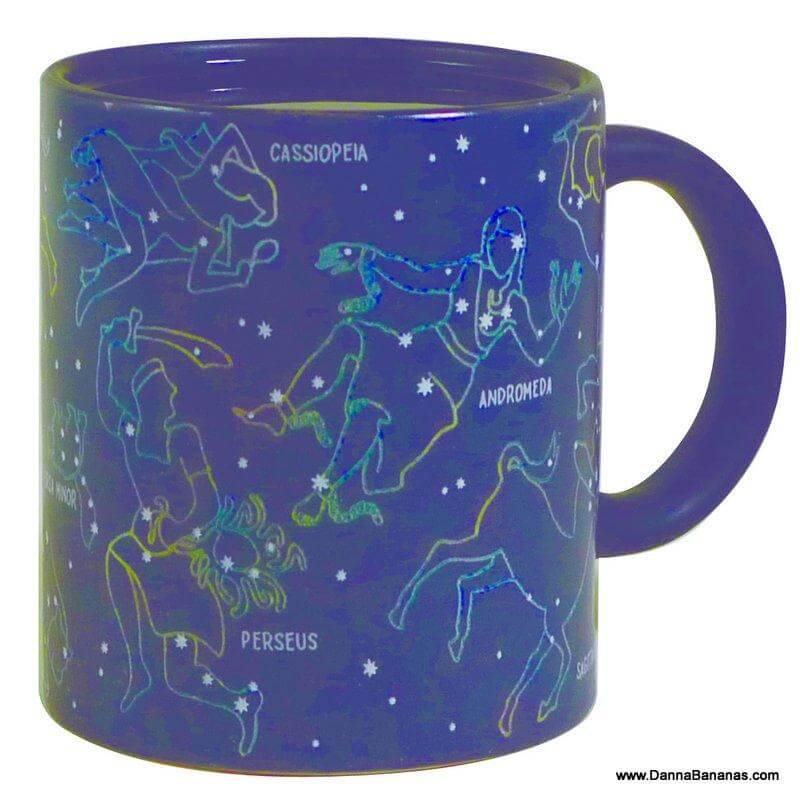 The Constellation Heat Change Mug from Danna Bananas is a blue mug with Cassiopeia, Andromeda, and Perseus against a starry backdrop—ideal for star gazers or astronomy lovers seeking a unique gift.