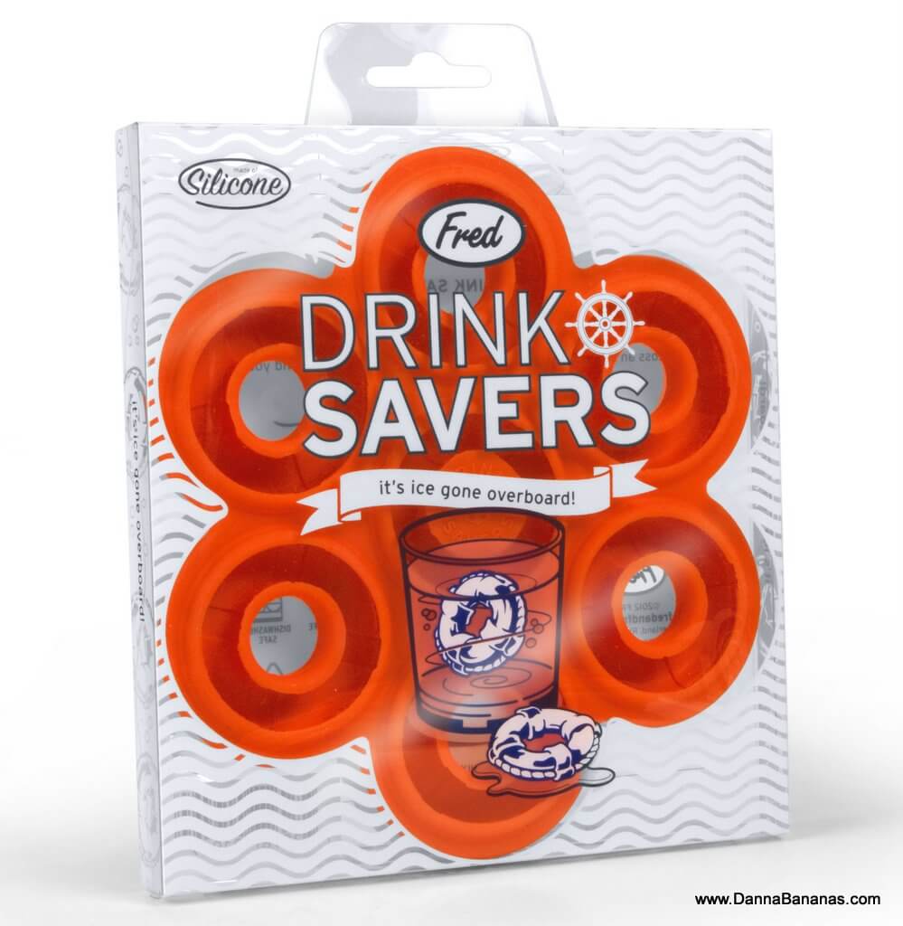 The image shows a packaging of "World Wide Fred Drink Savers" ice cube trays, designed to resemble lifebuoys. The packaging is orange with a transparent section displaying the round, lifebuoy-shaped trays inside. Text on the packaging reads, "It's ice gone overboard!