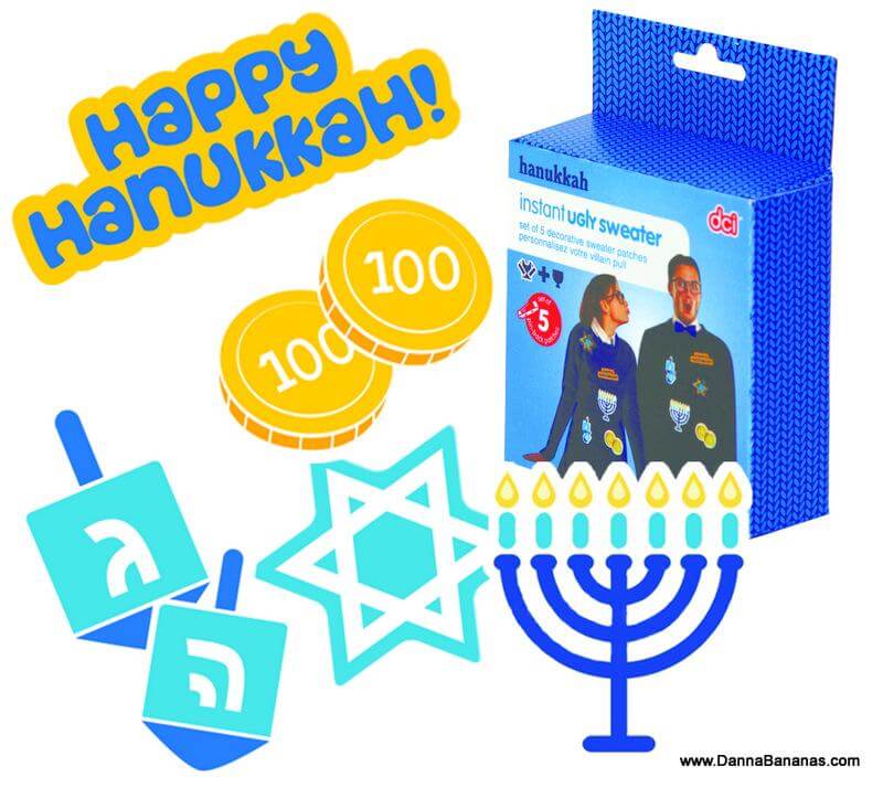 The vibrant Hanukkah-themed design features the text "Happy Hanukkah!" along with dreidels, gelt coins, a Star of David, and a menorah. The "Hanukkah Instant Ugly Sweater Kit" by Danna Bananas includes festive sweaters with embroidered patches and is modeled by two joyful individuals.