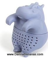 The whimsical Hippo Tea Infuser by Danna Bananas is a light purple silicone tea steeper shaped like a hippo. It stands upright and features small holes ideal for loose leaf tea, adding charm to your brewing experience. Visit www.DannaBananas.com for more details.