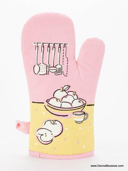 The "I've Got A Knife Oven Mitt" by Danna Bananas is a charming pink kitchen accessory with quilted insulation. It features a fruit bowl, sliced fruit, and cup on a sunny yellow background, with elegant kitchen utensils hanging above the bowl.
