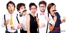 A group of five individuals, dressed in quirky attire and holding fake mustaches and glasses from the Danna Bananas Photo Booth - Photo Accessories, displays various expressions of surprise and amusement against a plain white background.