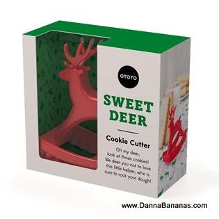 The packaging is green and white, showcasing a red deer-shaped cookie cutter. The box features the text "Sweet Deer Cookie Cutter" with a playful note expressing affection for the item. It's ideal for your favorite sugar cookie recipe! The brand name, Danna Bananas, and the website link www.DannaBananas.com are printed at the bottom right corner.