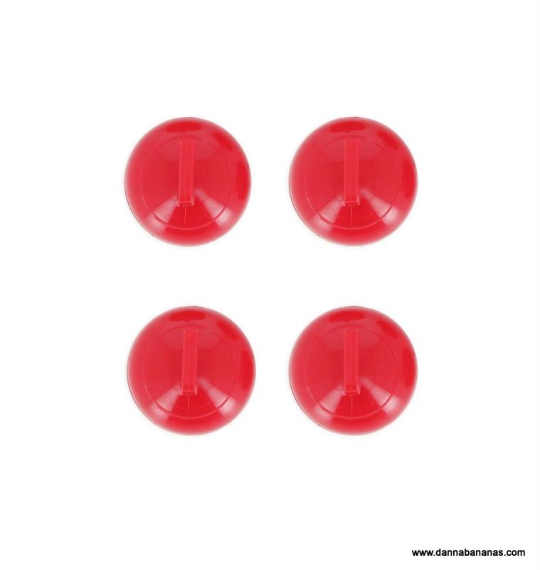 Four red plastic push buttons, set in a square pattern on a white background, evoke the strategic markers of the Danna Bananas Tabletop Curling Game.
