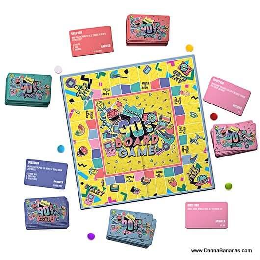 Introducing the Totally 90's Board Game by Danna Bananas, a nostalgic set featuring a central square board adorned with retro patterns. The game includes stacks of cards and small, colorful pieces, offering vibrant red, blue, and pink trivia questions and answers from the iconic '90s era.